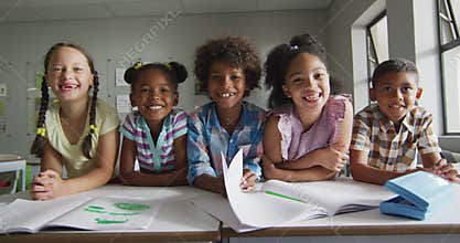 Video of happy diverse pupils learning together in classroom