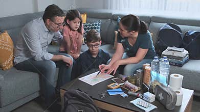 Mother explaining to her family the emergency assembly point