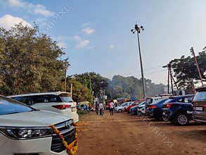 Stock photo of parked four wheeler car, tempo, auto rickshaw outside of temple area under