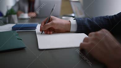 Entrepreneur hands writing paper document in office. Business meeting concept.