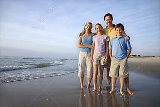 Smiling family on beach.