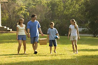 Family walking in park.