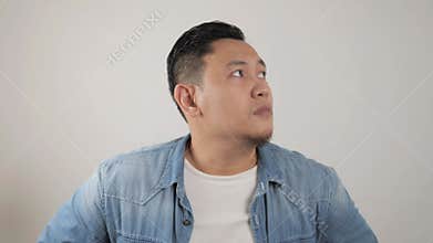 Portrait of young Asian man looked confuse and worried afraid of something bad