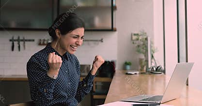 Happy Indian woman use laptop check email read fantastic news