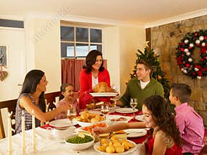 Hispanic family at home serving christmas dinner