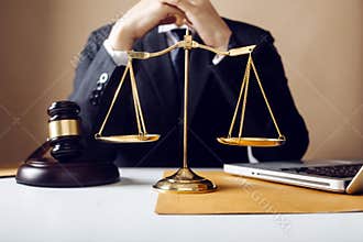 Business and lawyers discussing contract papers with brass scale on desk in office. Law, legal services, advice, justice and law c