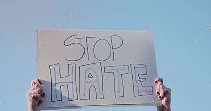 Woman At a Protest Holding a Stop Hate Sign