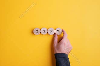 NSFW abbreviation spelled on wooden cut circles