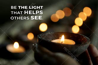 Inspirational quote - Be the light that helps others see. Be inspire and kindness concept with person holding a candle light.