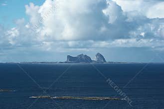 Silhouette of Træna island on the horizon far in the Norwegian sea