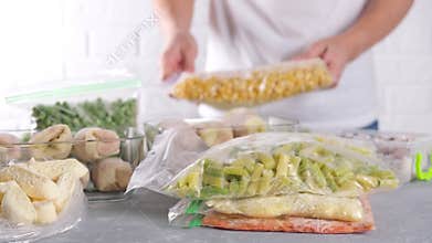 Frozen food in containers and bags on the table. Frozen vegetables.