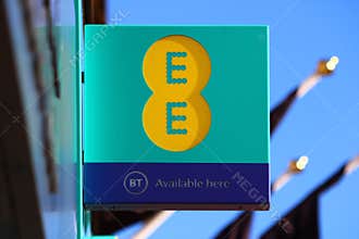 EE and BT Logos on a Sign Outside a Mobile Phone Shop