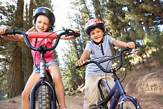 Two young children enjoying a bike ride