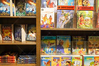 Kolkata, India, February 12.2021. A photo of bookshelf with many colored story books and graphic novel for sale inside a book shop