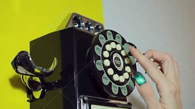 Amazed beautiful woman in retro style talking on telephone. Female talking old
