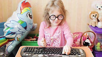 Happy little girl plays with bitcoins.