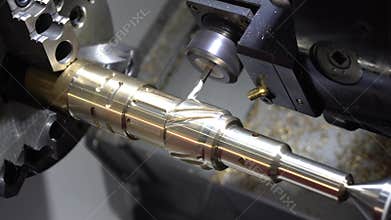 The CNC lathe or turning machine milling slot on the brass shaft with the flat end-mill tool.
