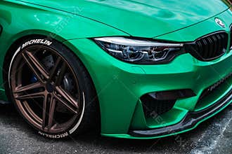 BMW M3 F80 Sport Car wrapped in green vinyl wrap equipped with AC Schnitzer wheels with low profile tires on