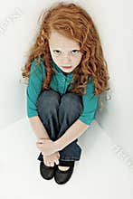 Worried Sad Girl Child in Sitting in Corner