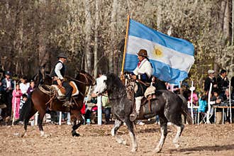 A Gaucho with Argentinian flag riding a horse in e