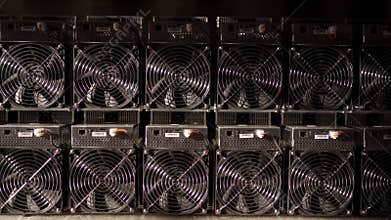 Bitcoin ASIC miners in warehouse. ASIC mining equipment on stand racks for mining cryptocurrency in steel container
