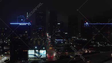 Ascending drone view reveal low traffic on highway and city lights in downtown at night. Dallas, Texas, US.