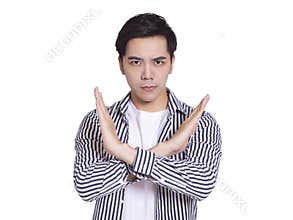 Young and handsome man, expressing rejection gesture, bigger than X gesture on his chest.Isolated on white background