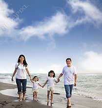 Asian Family walking On the Beach