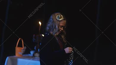 Smiling confident Caucasian little girl with metal rope on Halloween night in forest outdoors. Courageous brave kid in