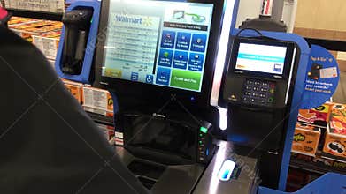 The motion of man scanning health food at self-checkout counter