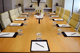 Close - up of Meeting Table with Stationery and Glasses