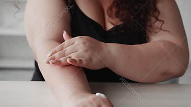 body lotion skin moisturizing overweight woman arm