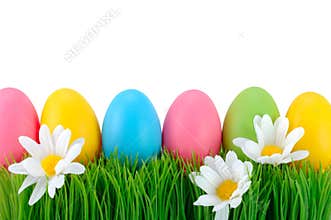 Easter colored eggs on the grass.