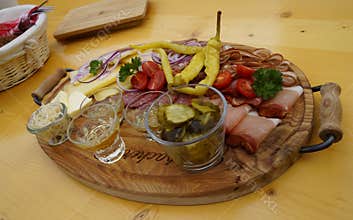 a rustic meal of cheeses, cold cuts and schnaps in the Austrian Alps (Tannheimer Valley in Austria)