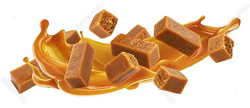 Caramel candies with caramel sauce splash isolated on white background