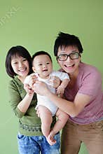 Family (Mother, father and small baby) smile face