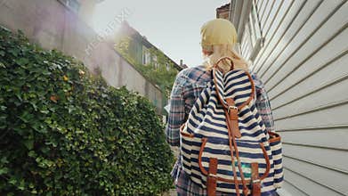 Tourist with a map in her hands walking through the narrow streets of Bergen in Norway. Holidays in Scandinavia