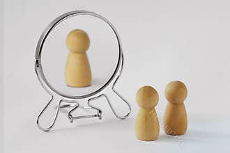 Couple of pawns looking in the mirror with just one of them reflected in it - Concept of egoism and narcissist