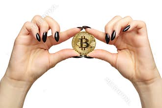 Female hands with black nails manicure and golden bitcoin in fingers. Isolated on white background