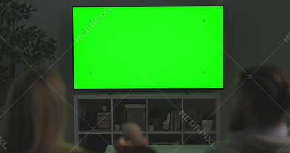 Couple watching green screen TV