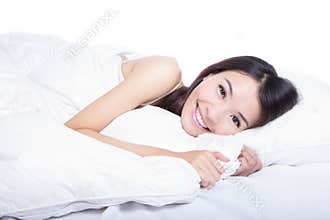 Woman smile face close up lying on the bed