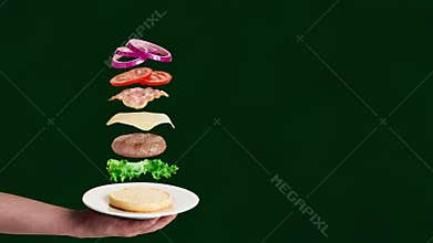 Hamburger ingredients falling on the bun.