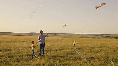 Happy family park Father and sons in the park launch flying kite into sky Childhood dream fly Boys child with dad play