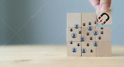 Attracting online customer and lead generation concept. Digital inbound marketing, customer retention strategy.Hand hold wooden cu