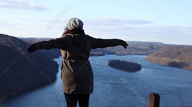 Beautiful woman stretching out her arms while looking out towards a breathtaking view of the Susquehanna  a