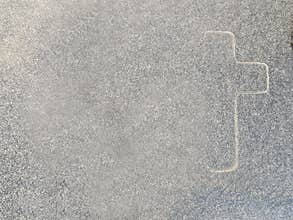 The outline of a cross on marble