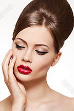 Vintage style model. Lips make-up, shiny hairstyle