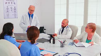 Expert doctor talking about medical technology with medical staff