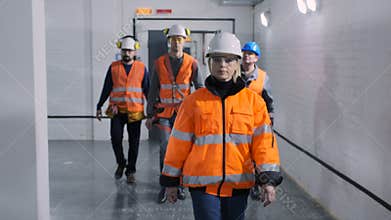 Woman engineer colleagues walk along electrical substation