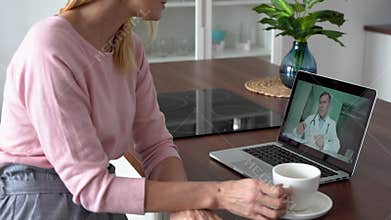 Middle aged female patient getting online telemedicine consultation at home.